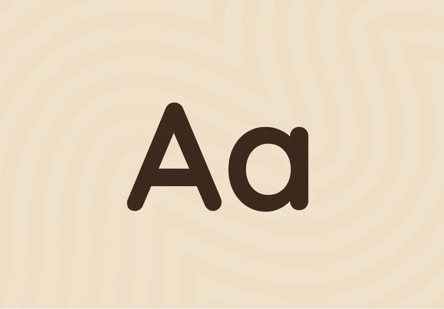 Alphabet card front: the letters Aa in walnut brown on warm cream.